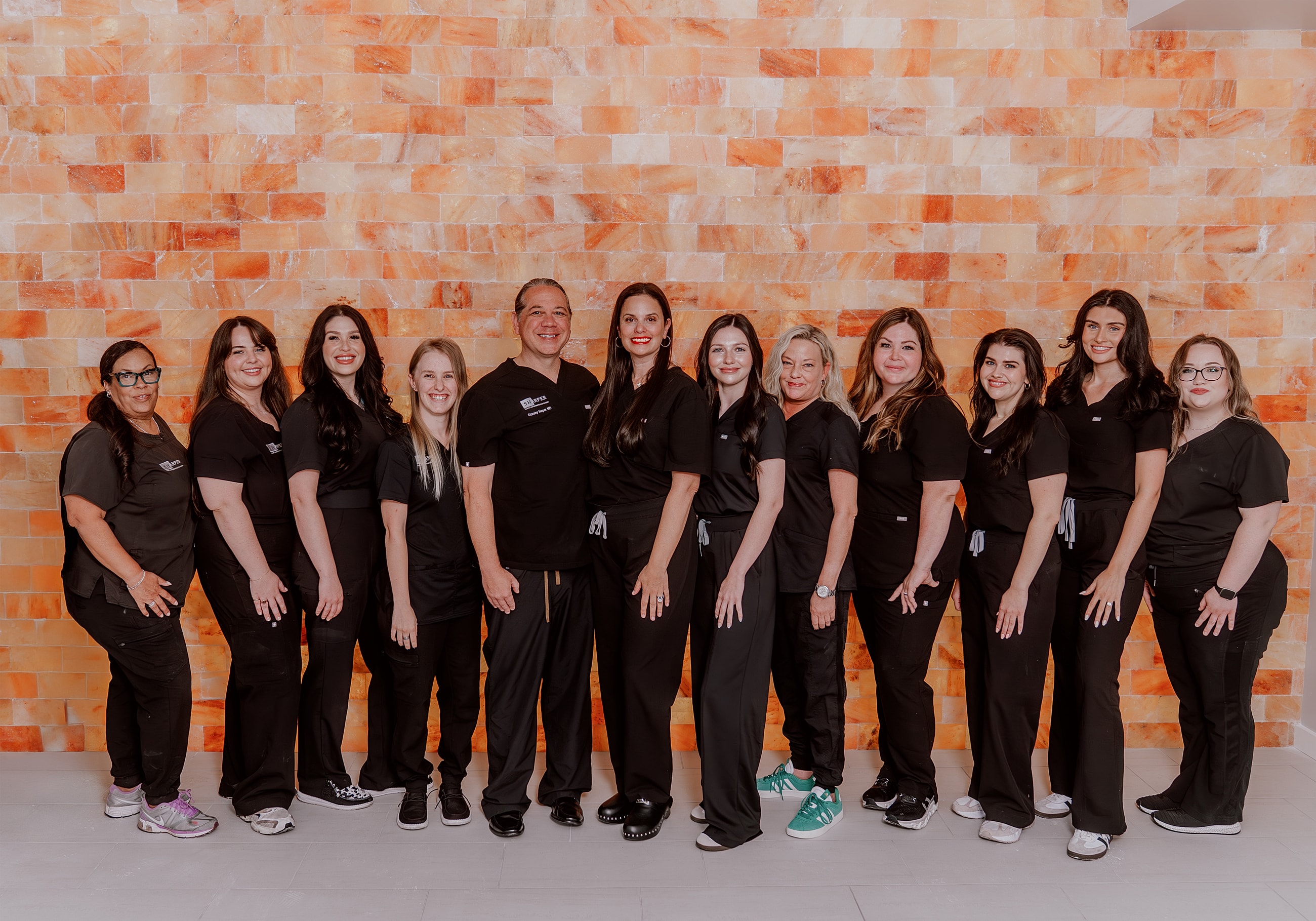 Healthcare team posing in front of salt wall.