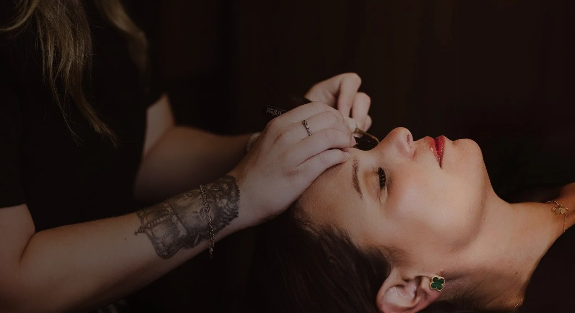 Woman receiving makeup application in a salon.