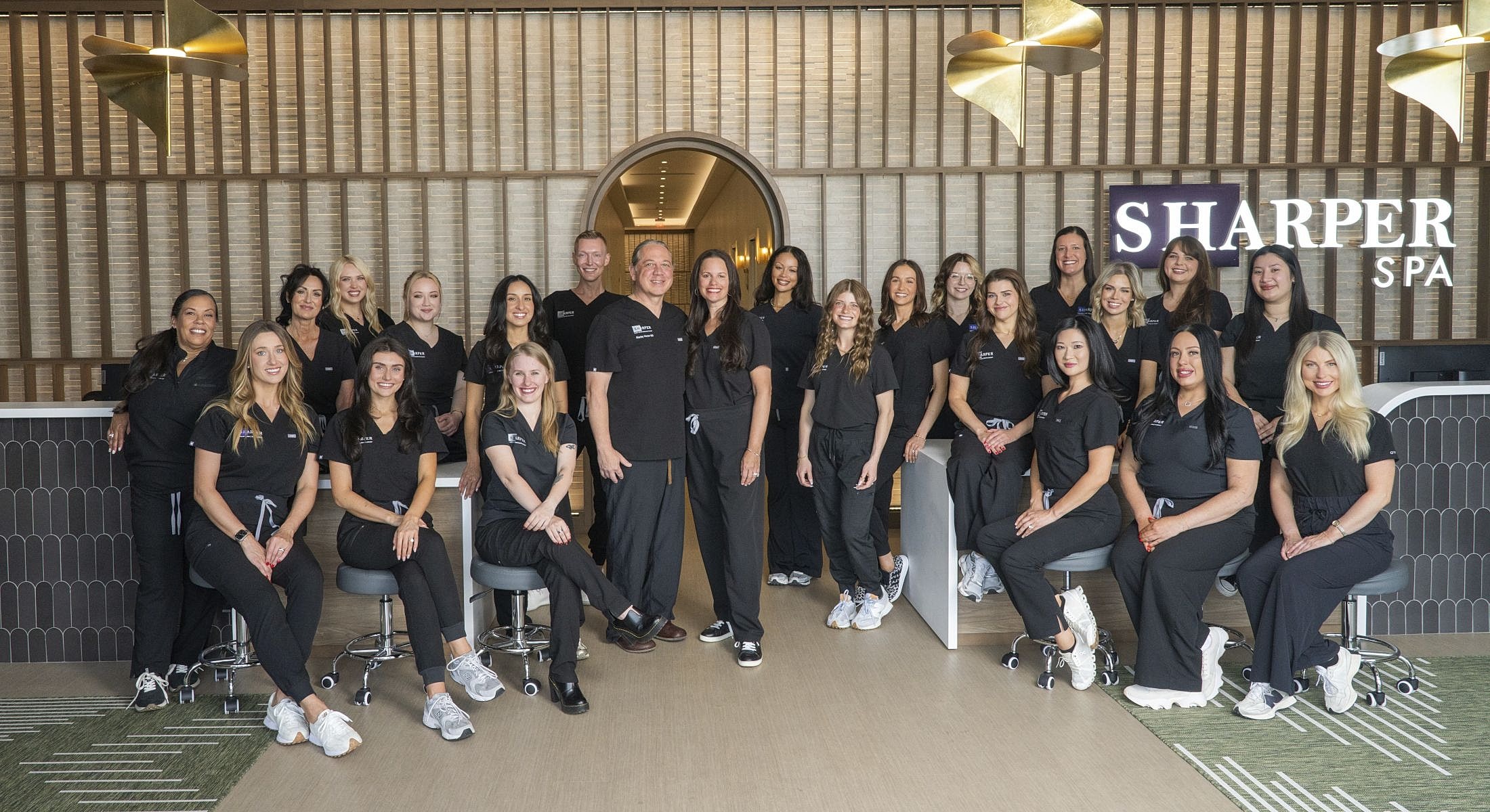 Spa team posing in modern environment.